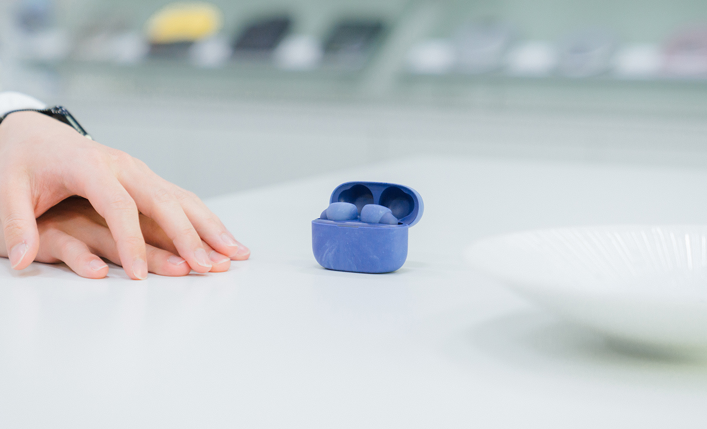 Headphones in a blue case are placed on the table