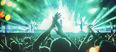 Image of people dancing at a live concert.