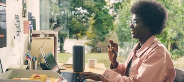 Image of a person with their laptop and the SRS-XE300 X-Series Portable Wireless Speaker