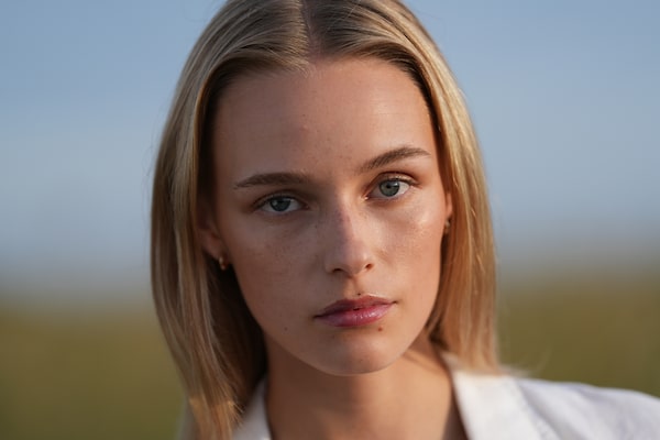 Example image showing a close-up portrait of a woman’s face, looking straight at the camera