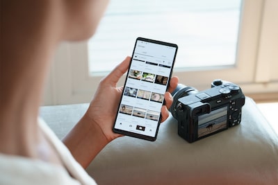 Fotografia de uma mulher a olhar para uma fotografia transferida da câmara